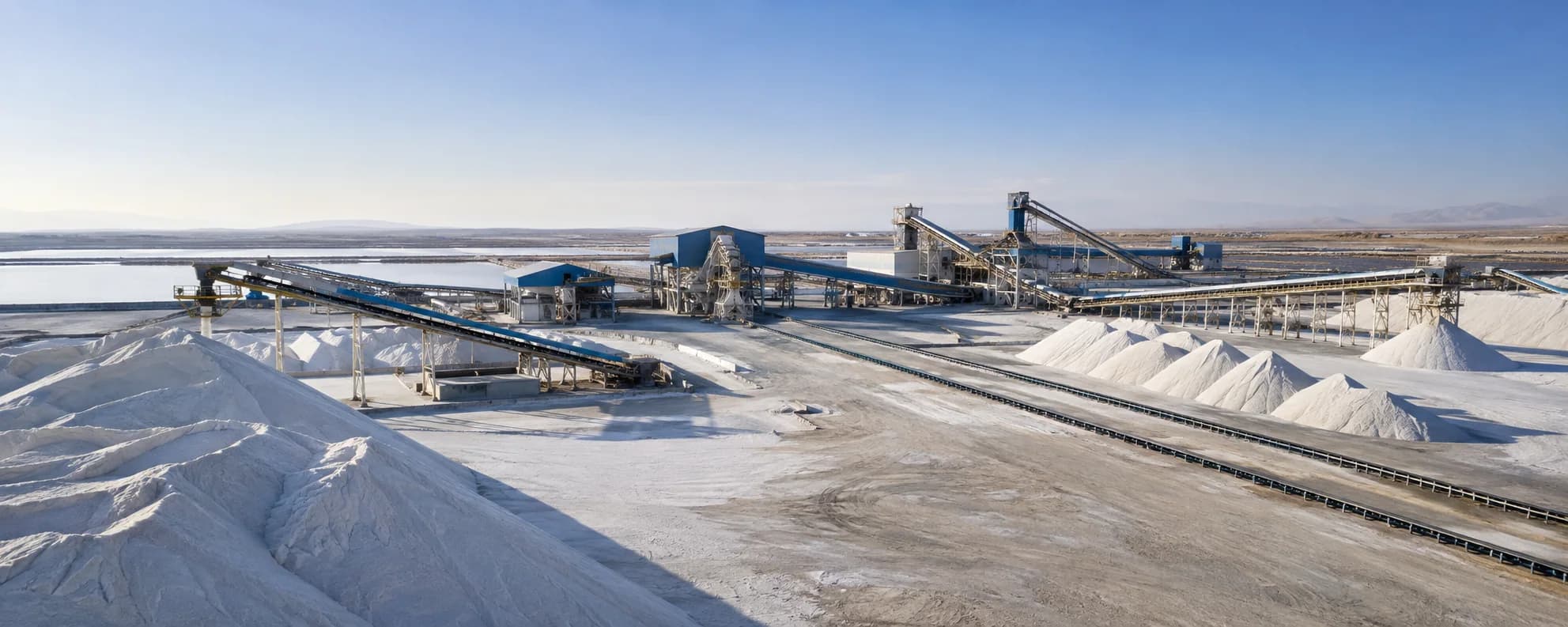Salt production facility and white mineral stockpiles under an open sky